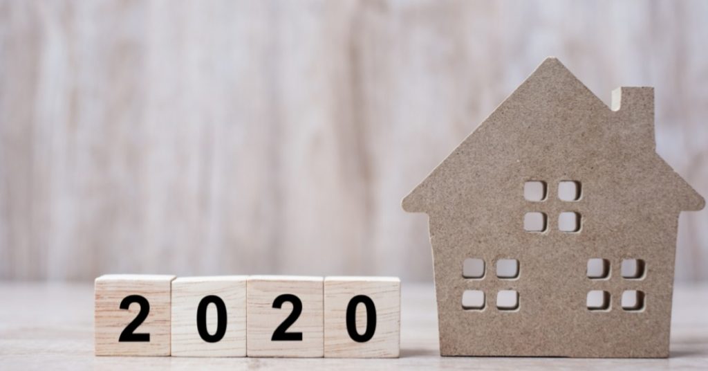 Image of a home figurine next to tiles that say "2020."