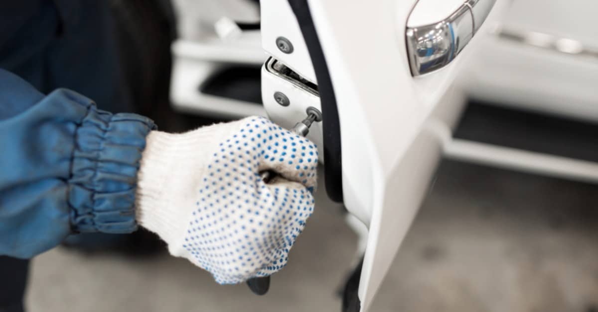 Image of a car locksmith repairing a car door lock.