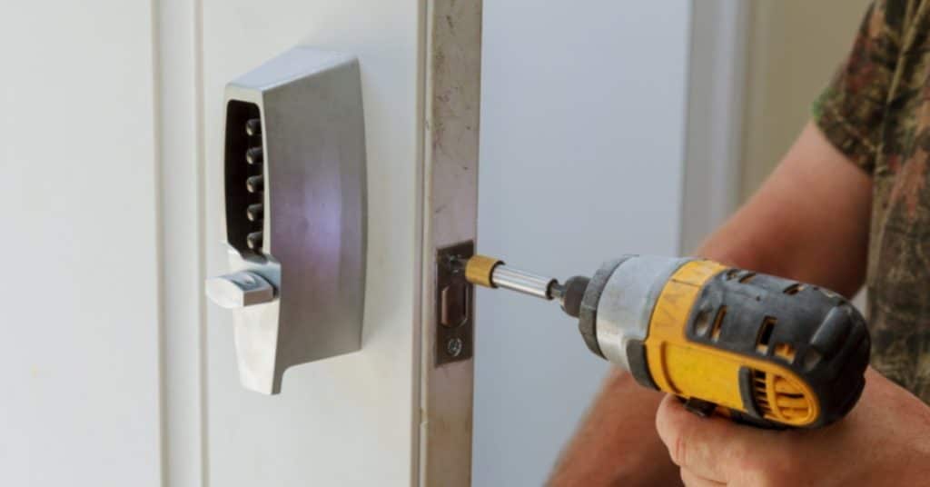 Image of a locksmith improving security on a door.