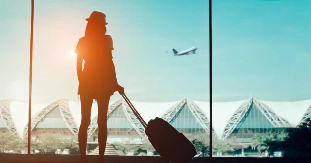 Image of a woman standing in the airport.